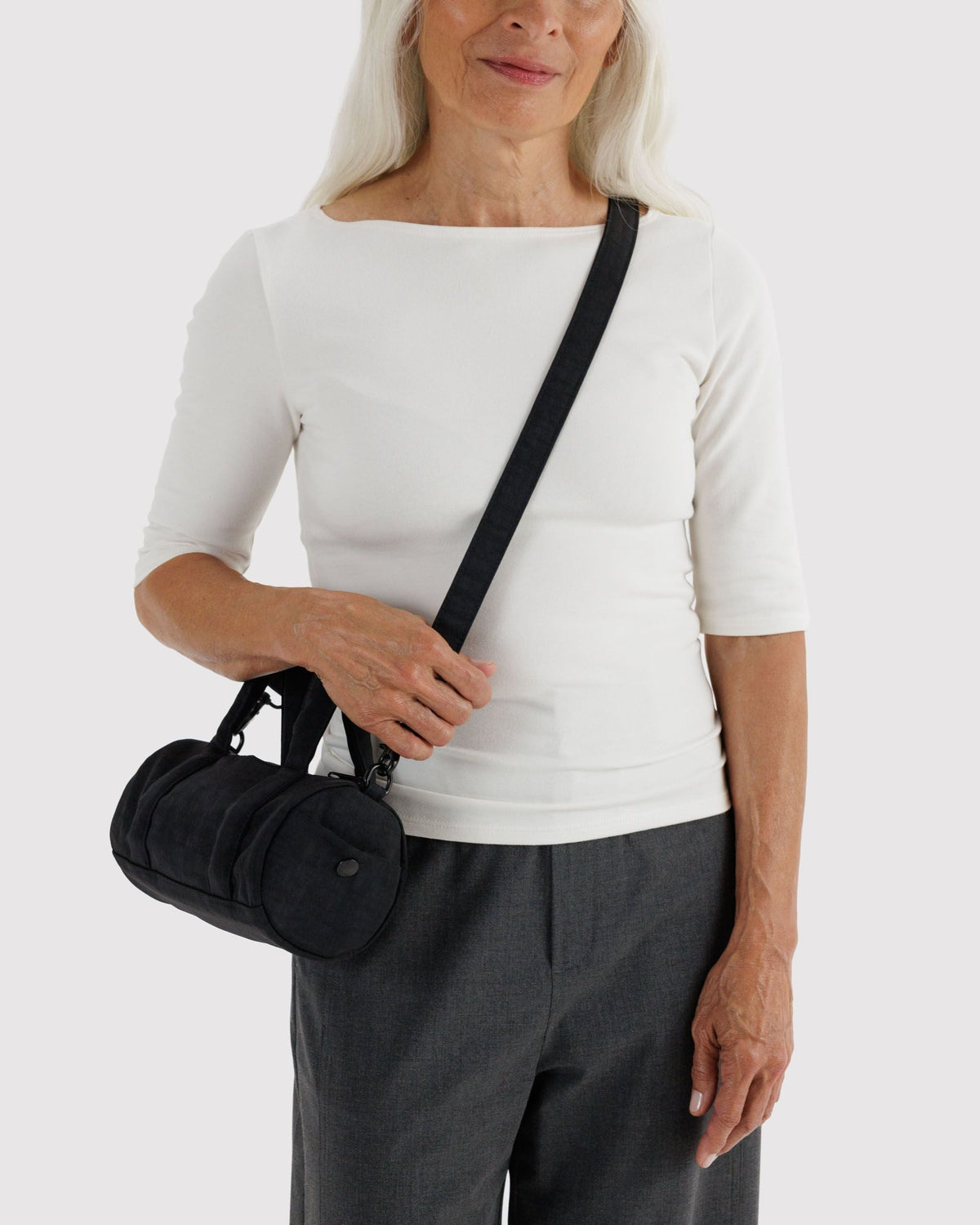 BAGGU Small Nylon Duffle Bag in Black, worn crossbody | Black