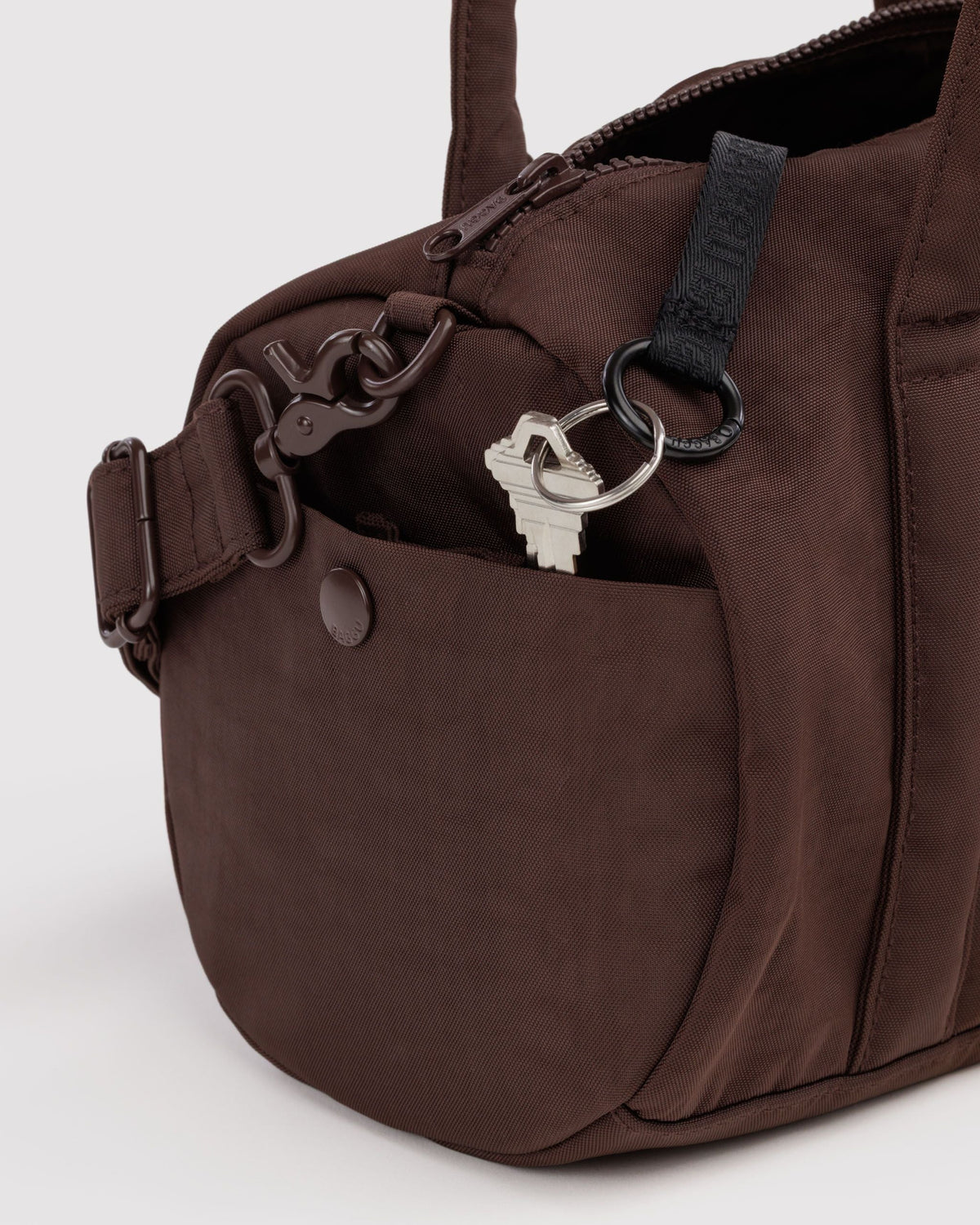 BAGGU Nylon Duffle Bag in Coffee, side pocket and key leash detail | Coffee