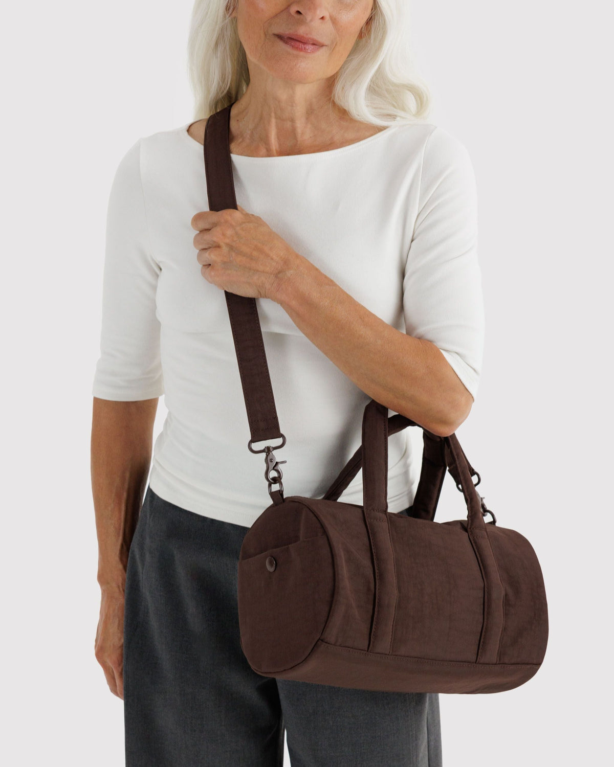 BAGGU Nylon Duffle Bag in Coffee, worn crossbody | Coffee