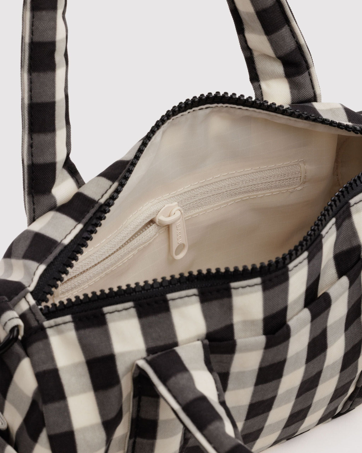 BAGGU Small Nylon Duffle Bag in Black and Cream Gingham, interior zip pocket detail | Black and Cream Gingham