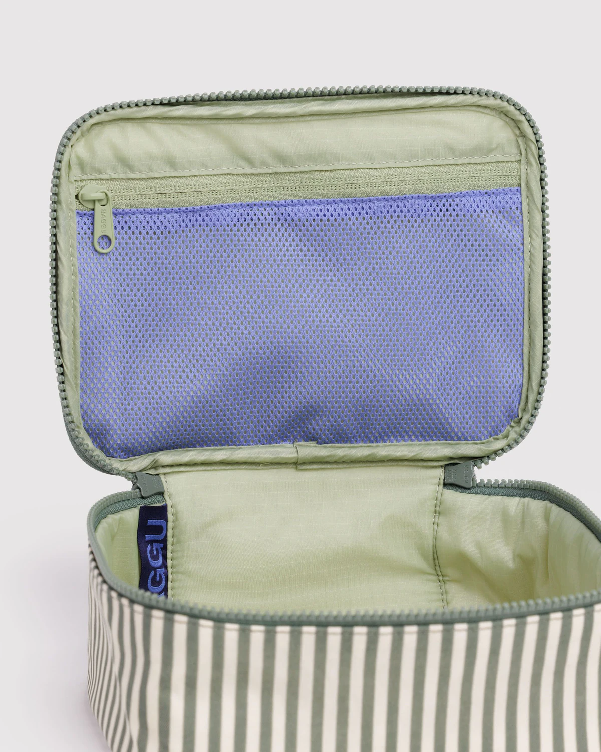 Open travel pouch with green exterior and blue interior on a white background Baggu Small Cosmetic Case | Sage Stripe