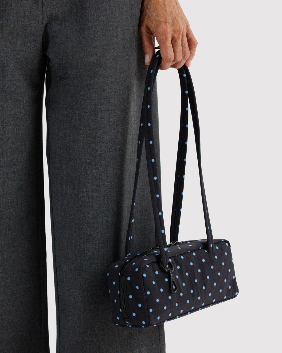 Baggu Small Nylon Bowler Bag carried by hand | Black and Sky Blue Micro Dot