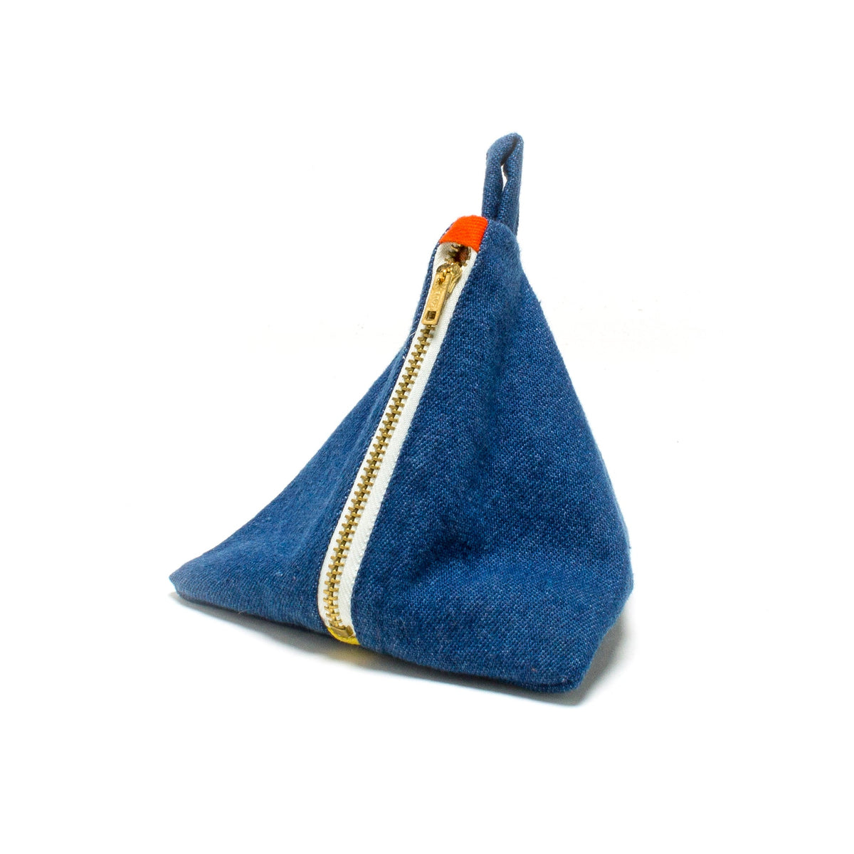 DEGEN Blue denim pyramid pouch shown at an angle with a metal zipper and fabric loop