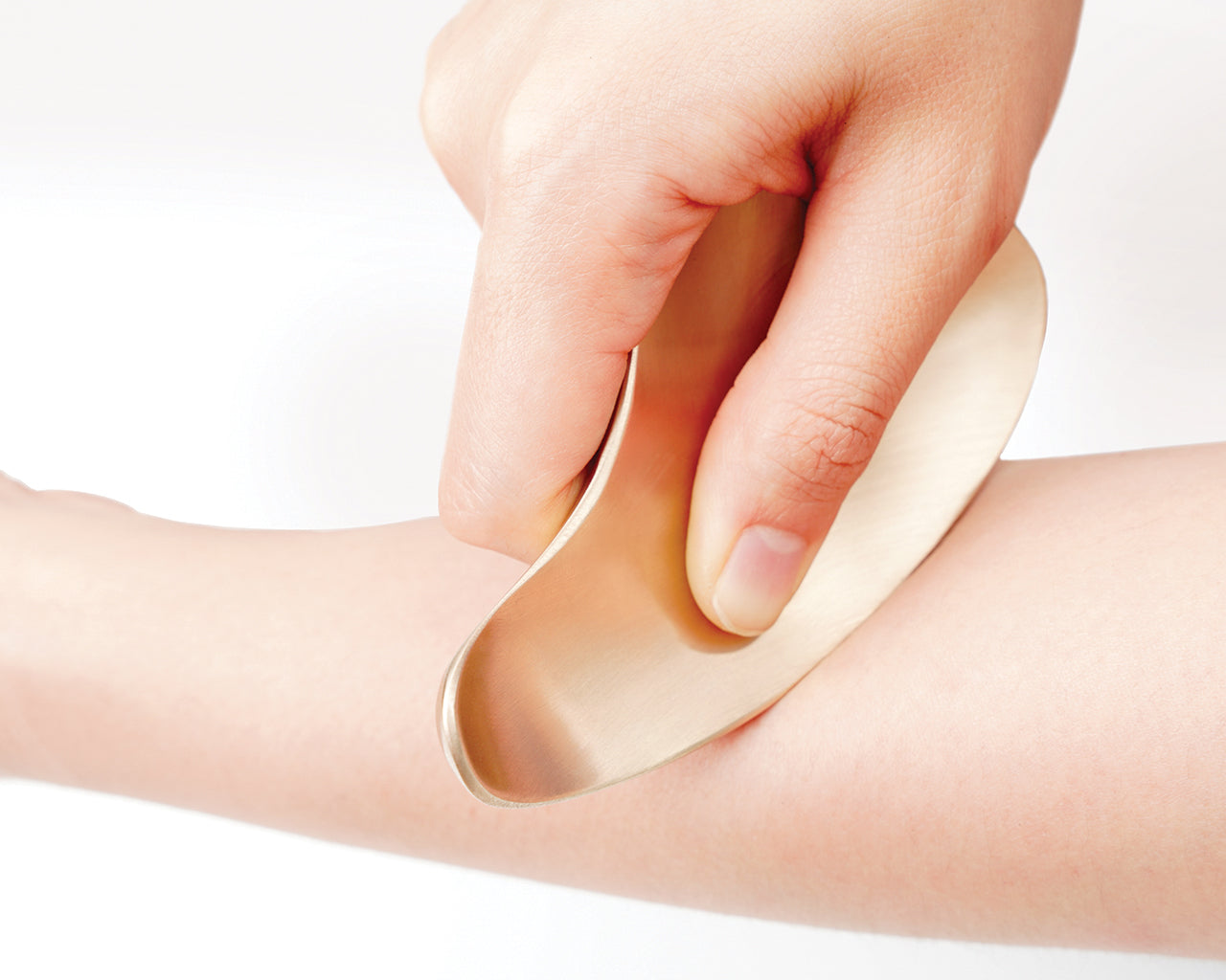 A person massaging her body with GeoChangYugi Lily Korean Guasha