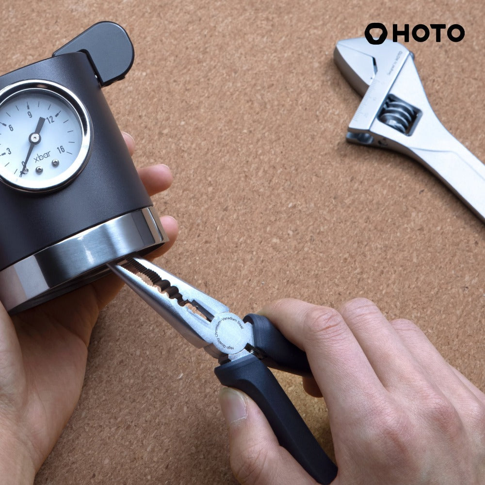 Person using a tool with a gauge on a brown surface, with 'HOTO' branding.