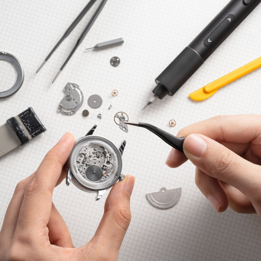 Watch repair process with hands using tools on a white surface HOTO Electric Precision Screwdriver Kit Pro
