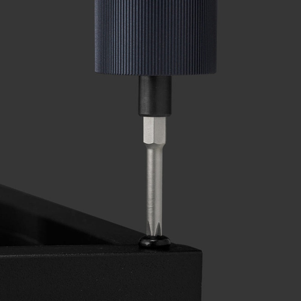 Close-up of a screwdriver with a black handle and metal shaft on a dark background HOTO 3.6V Electric Screwdriver Kit Pro