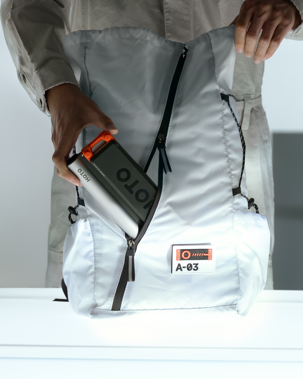 Person holding a backpack with a HOTO SNAPBLOQ