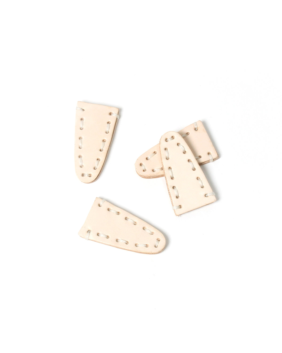 DEGEN Four light natural leather scissor tip protectors with stitched edges on a white background