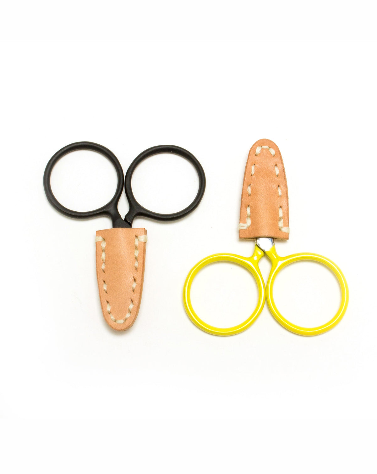 DEGEN Natural leather scissor tip protectors fitted to black and yellow round-handled scissors
