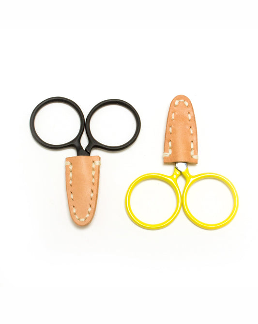 DEGEN Natural leather scissor tip protectors fitted to black and yellow round-handled scissors