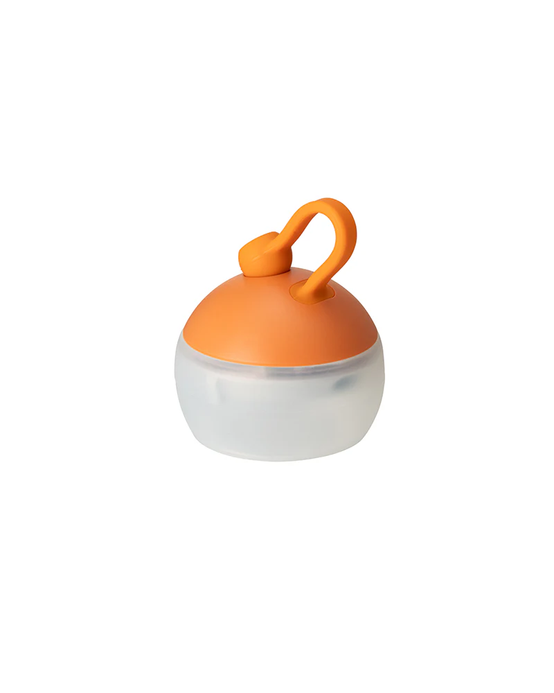 Small round container with an orange lid on a white background | Orange