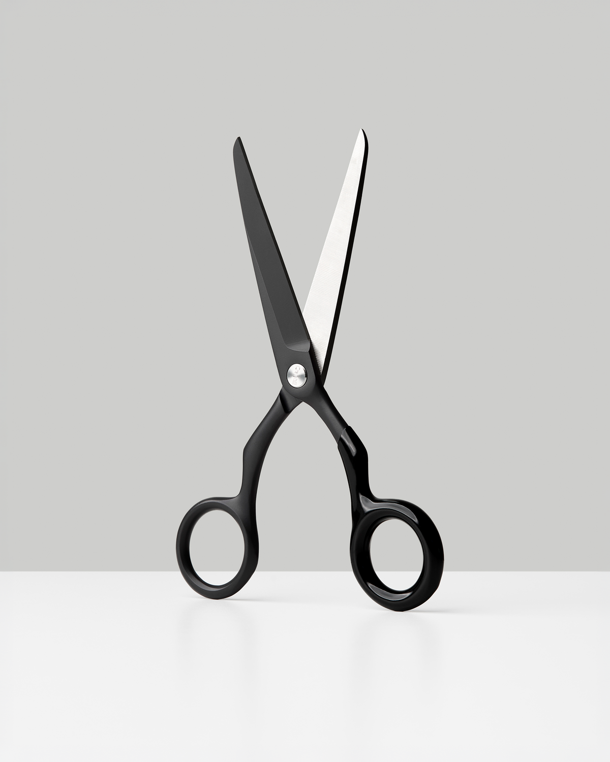 Craighill Spectra Scissors in Charcoal + Black, shown open against a gray background | Charcoal + Black