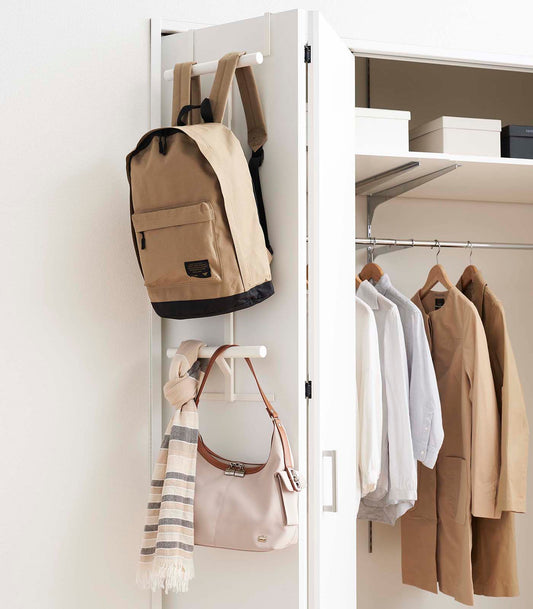 Yamazaki Home Tower Over-the-Door Backpack Hanger - Steel, white hanger holding backpack, handbag and scarf on closet door