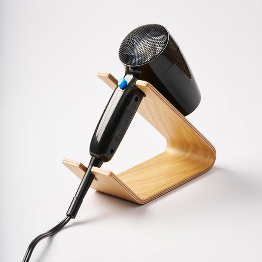 Yamazaki Rin wooden hair dryer stand in the Ash finish, shown supporting a separate black hair dryer.