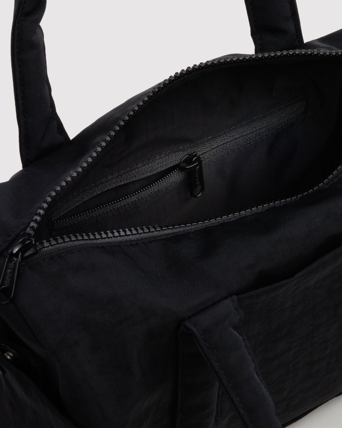 BAGGU Nylon Duffle Bag in Black, interior zip pocket detail | Black