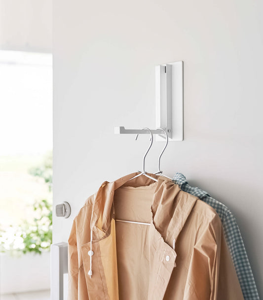 Yamazaki Home Tower Magnetic Folding Hook - Steel, white hook holding two jackets on hangers