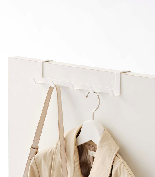 Yamazaki Home Smart Over-the-Door Hanger - Steel, white hanger on door holding a jacket and bag