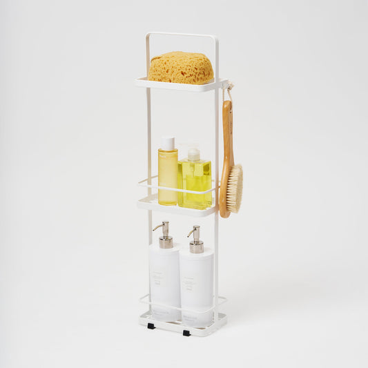 White Yamazaki Tower three-tier shower caddy with separate bottles, sponge and hanging bath brush