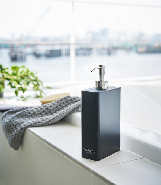 Yamazaki Home Tower Rectangle Shower Dispenser - Three Styles, black shampoo dispenser beside a bathtub