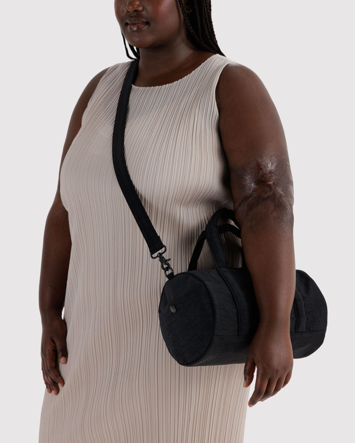 BAGGU Nylon Duffle Bag in Black, worn crossbody | Black