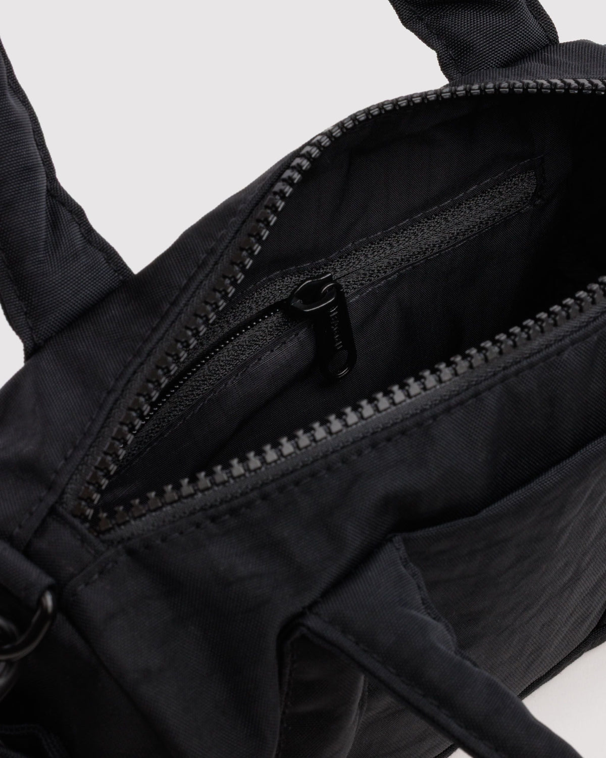 BAGGU Small Nylon Duffle Bag in Black, interior zip pocket detail | Black
