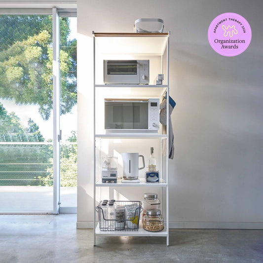 White five-shelf storage rack styled with kitchen appliances and pantry items; image displays an Apartment Therapy 2026 Organization Awards badge.