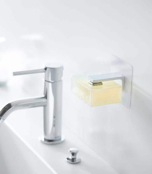 Yamazaki Home Tower Traceless Adhesive Magnetic Soap Holder, white holder suspending soap beside faucet