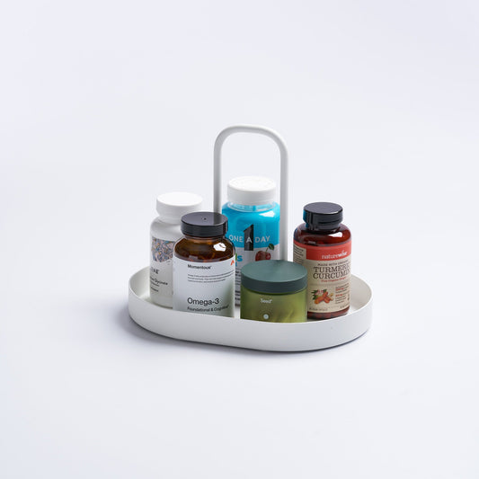 White Tower vanity tray with tall handle holding separate supplement bottles and jars