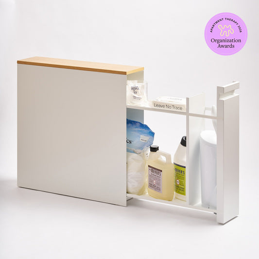 White pull-out bathroom cabinet with wood top and shelves extended, shown with an Apartment Therapy 2026 Organization Awards badge.
