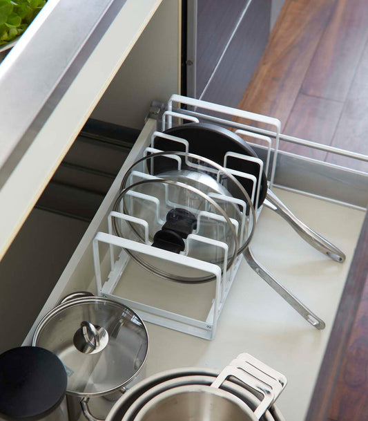 Yamazaki Home Tower Adjustable Pot Lid and Frying Pan Organizer, white organizer separating lids and frying pans in drawer