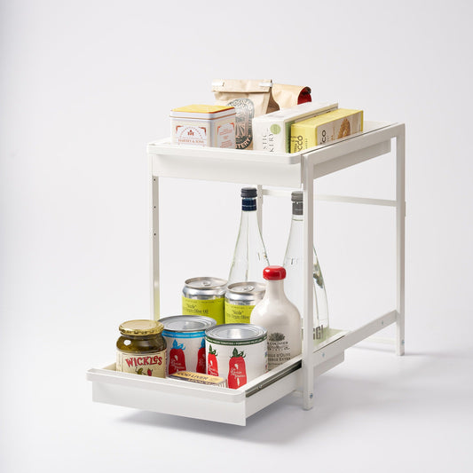 White two-tier pull-out shelf holding pantry items, with the lower drawer extended; contents shown for styling.