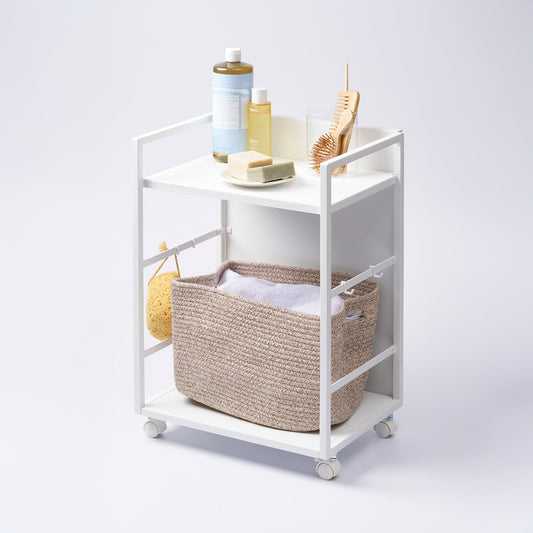 Yamazaki Home Tower Two-Tier Hideaway Storage Cart - Steel, white cart holding bathroom items and laundry basket