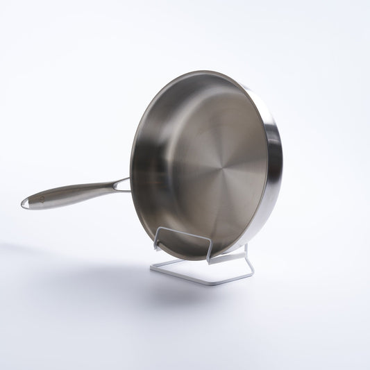 White Tower frying pan stand holding a separate stainless-steel frying pan upright