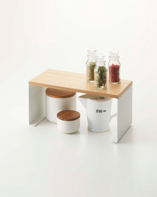 Yamazaki Home Tosca Stackable Countertop Shelf - Two Sizes - Steel + Wood, Small shelf holding spices above storage jars