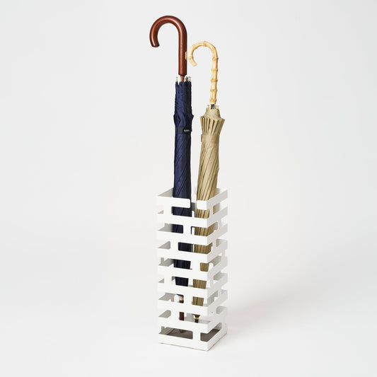 White Yamazaki Brick square umbrella stand with an open brickwork-pattern frame, shown holding two separate long umbrellas.