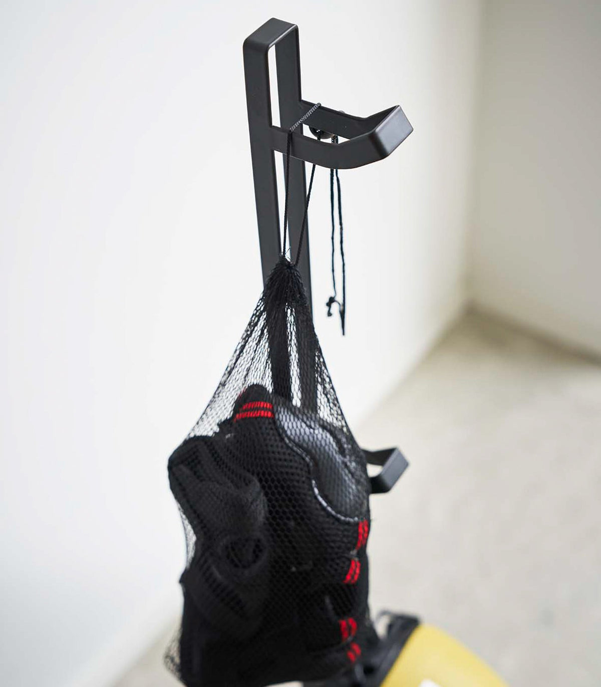 Yamazaki Home Tower Kids' Helmet Stand - Steel, close-up of hook holding a bag of protective gear