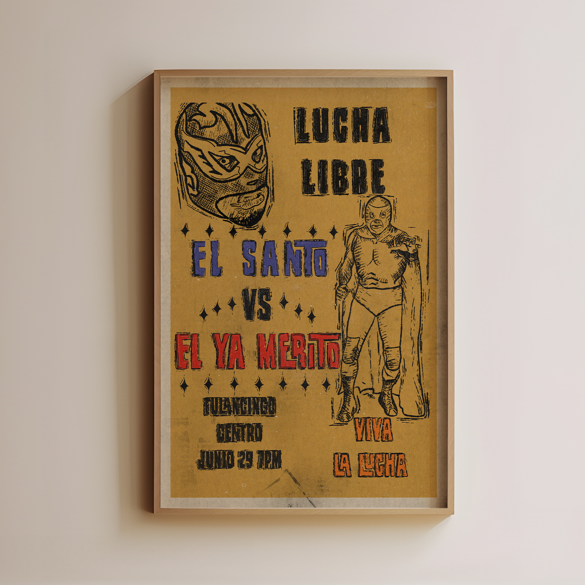 Lucha Libre art print with masked-wrestler illustrations and bold blue, red and black lettering on a yellow background, displayed in a light wood frame.