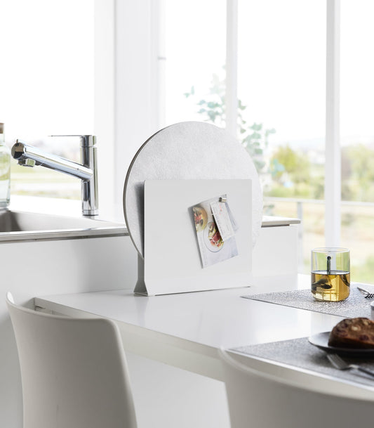 Yamazaki Home Tower Placemat and Tray Stand - Steel, white stand holding round placemat beside sink