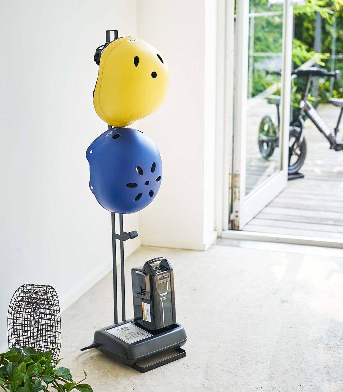 Yamazaki Home Tower Kids' Helmet Stand - Steel, black stand holding two helmets by an entryway