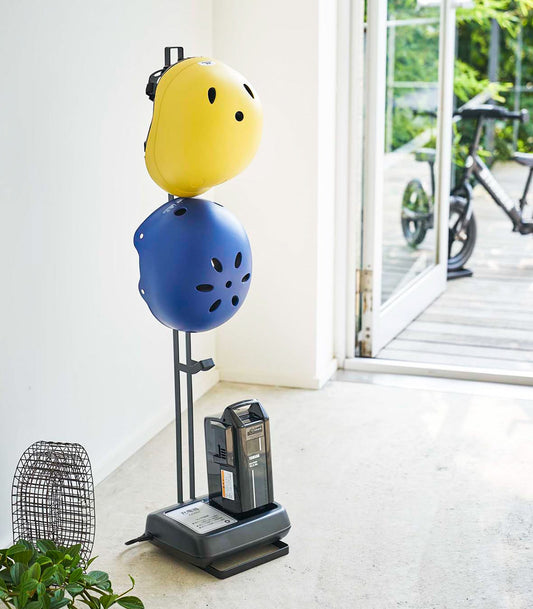 Yamazaki Home Tower Kids' Helmet Stand - Steel, black stand holding two helmets by an entryway