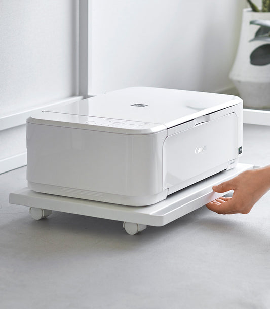 Yamazaki Home Tower Rolling Caddy - Steel, 66 lb Capacity — hand using the white caddy handle beneath a printer.