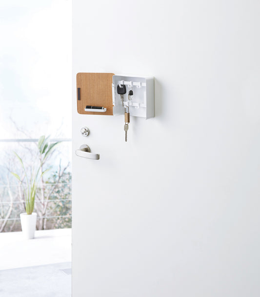 Yamazaki Home Rin Magnetic Key Cabinet - Steel + Wood, open Ash cabinet with white steel interior holding keys on door