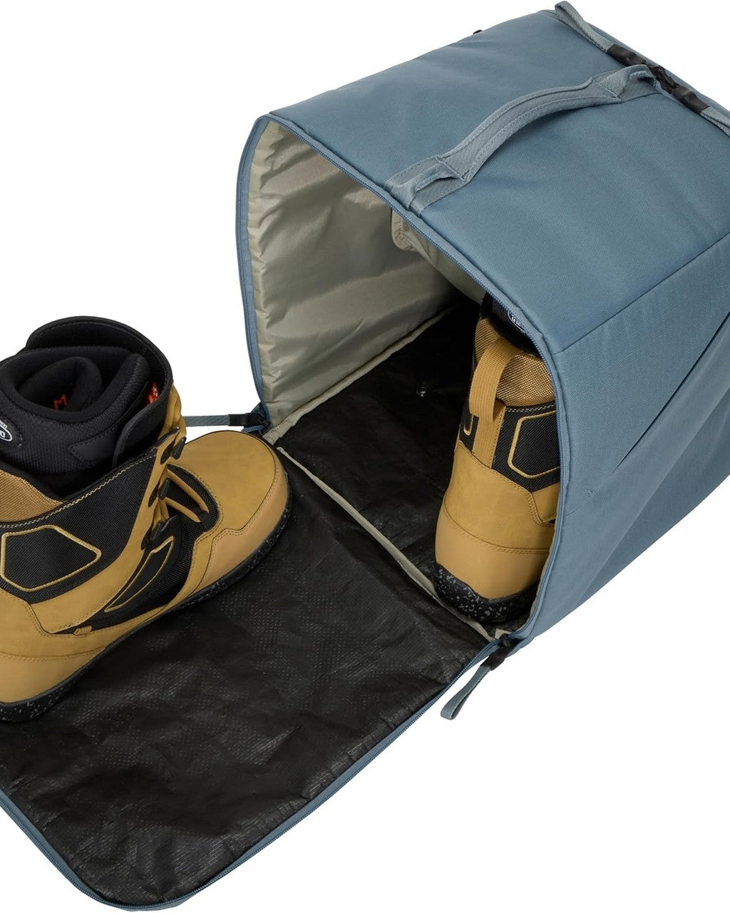 Blue boot bag with tan boots inside on a white background Thule Roundtrip Boot Bag 35L | Mid Blue