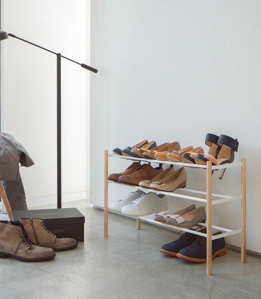 Yamazaki Home Plain Expandable Shoe Rack (18" H) - Steel + Wood — white expandable shoe rack with wood sides holding footwear
