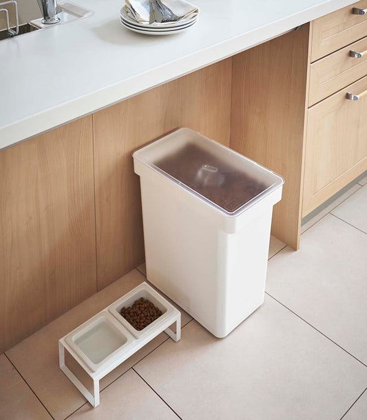 Yamazaki Home Tower Rolling Airtight Pet Food Container - 25 L, closed white rolling container beside pet bowls