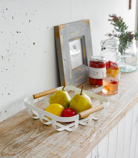 Yamazaki Home Tosca Fruit Basket - Steel + Wood, white fruit basket with pears and citrus on a kitchen counter