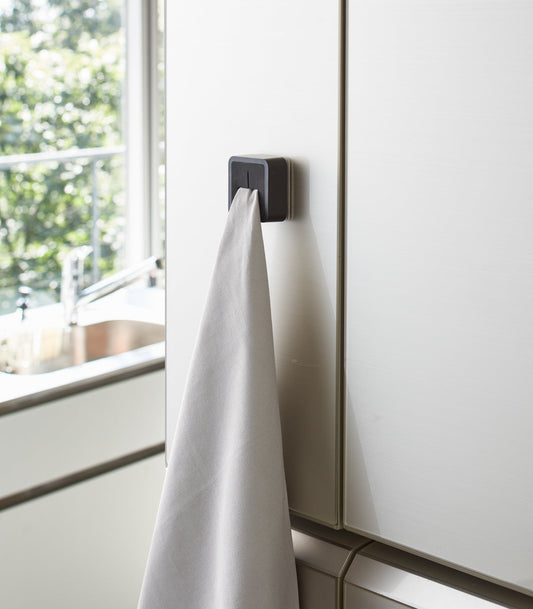 Yamazaki Home Tower Traceless Adhesive Kitchen Towel Holder - Black, black holder gripping towel on refrigerator