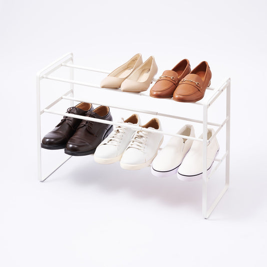 Yamazaki Home Frame Three-Tier Expandable Shoe Rack - Steel — white rack with shoes on its tiers.