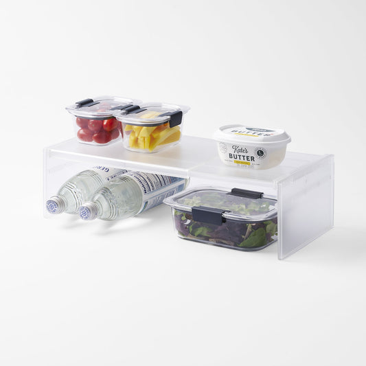 Yamazaki Home Tower Two-Way Adjustable Refrigerator Shelf — white shelf with food containers above and bottles below.